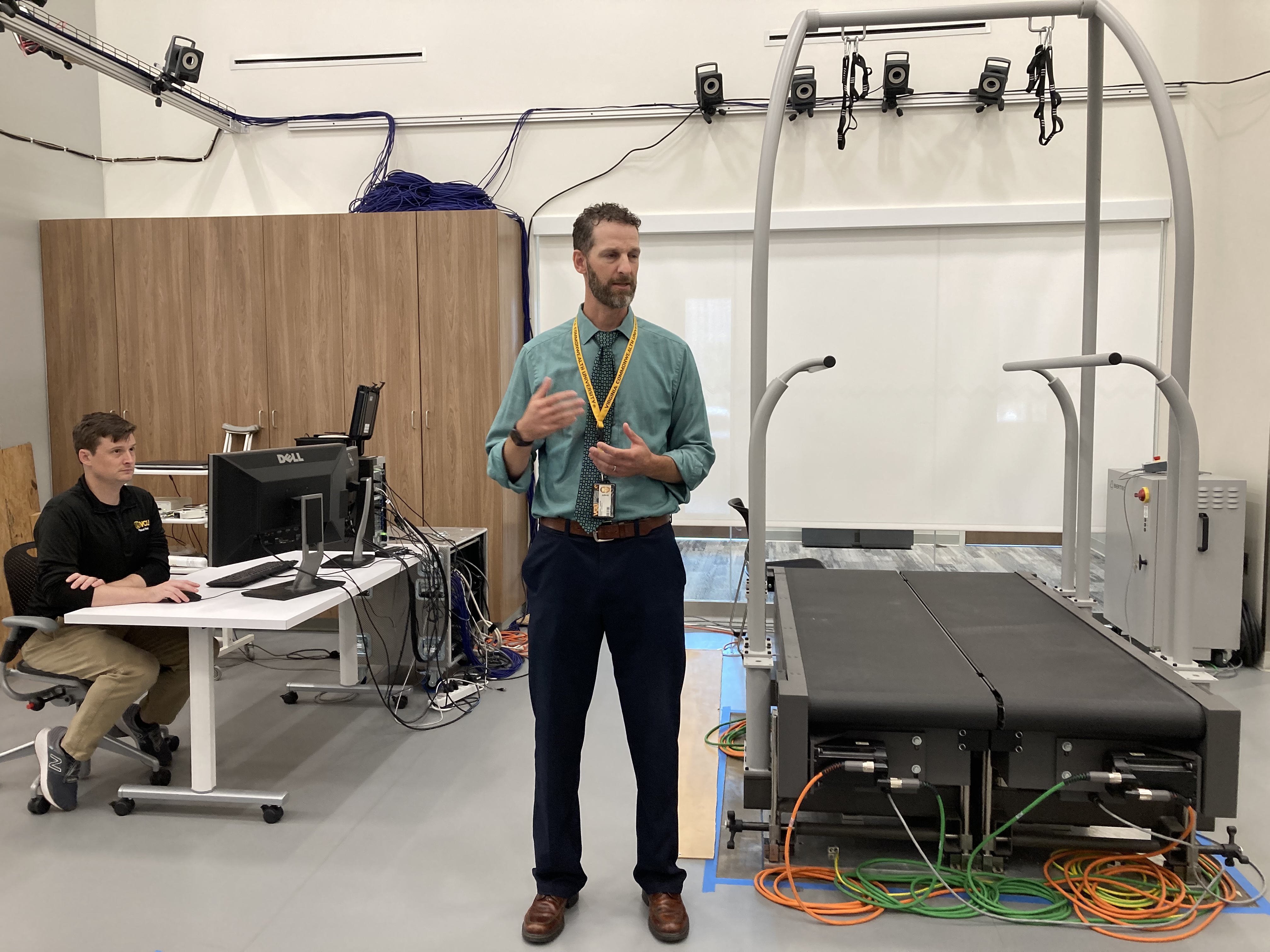 Ben Darter standing in front of split-belt treadmill