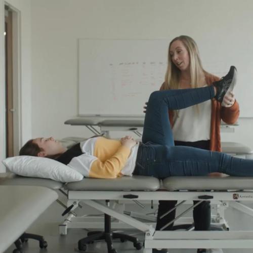 Feather Wright assisting patient with physical therapy