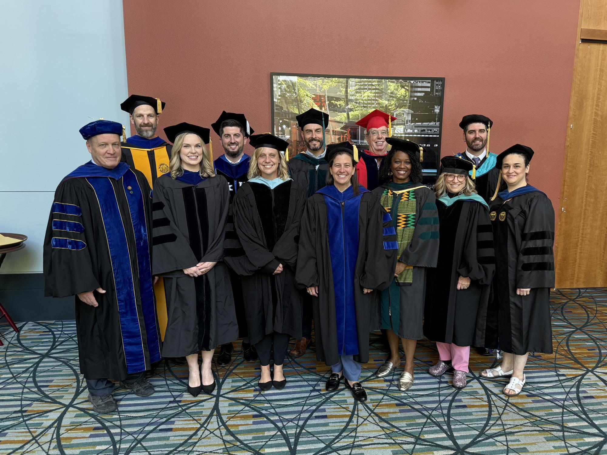 PT faculty at 2026 graduation in cap and gown