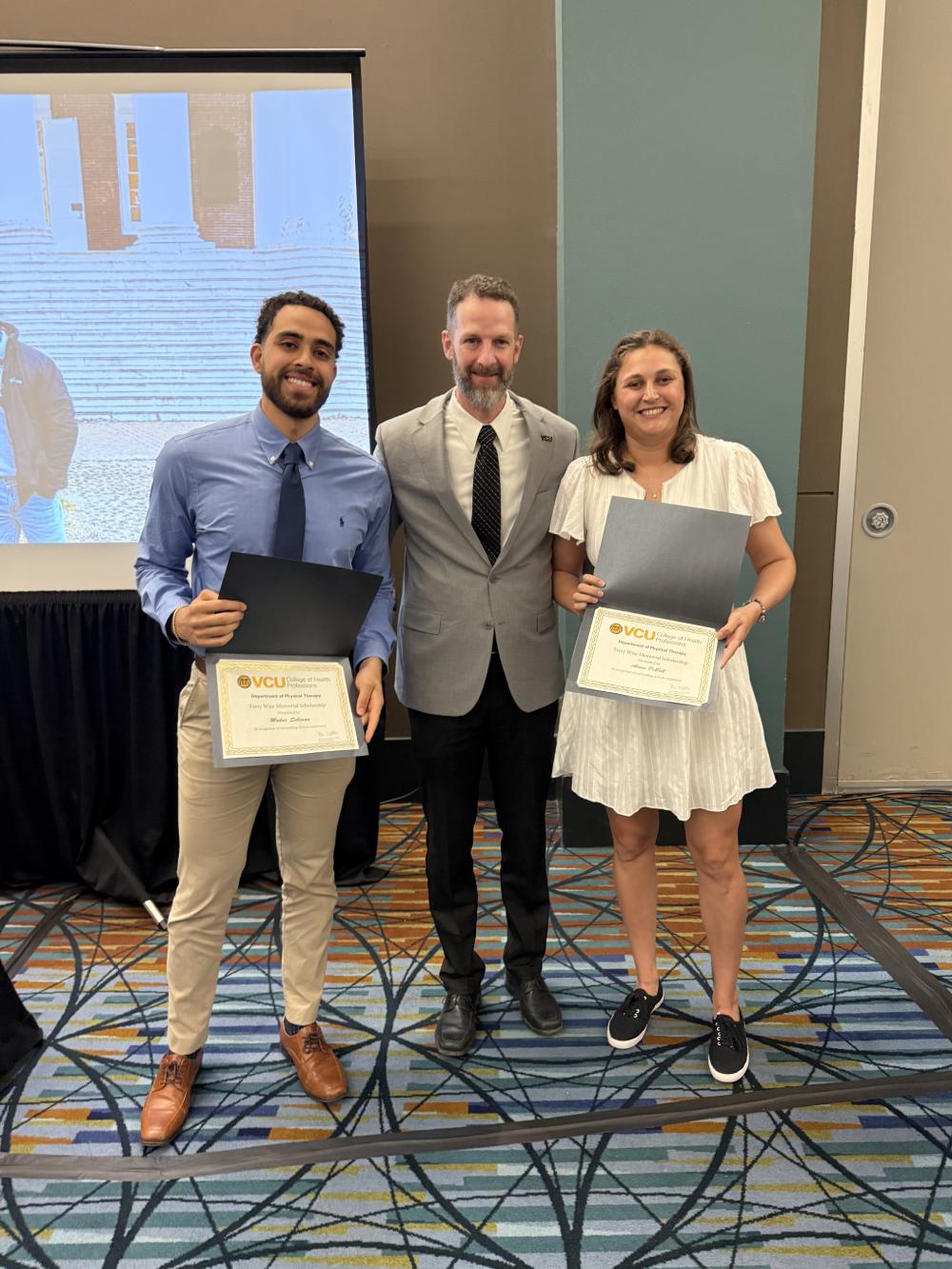Aimee DeBell and Makar Soliman presented with the Terry Wise Memorial scholarship by Dr. Ben Darter