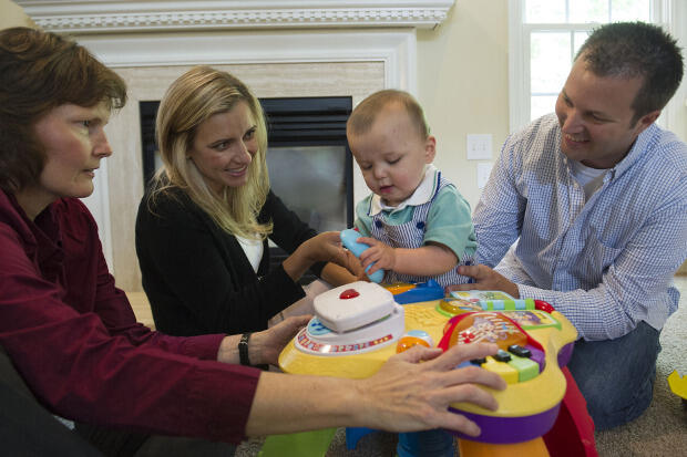 Shaaron Brown, DPT, a pediatric physical therapist, works with Miles Mrozinski at home with his parents, Whitney and Brent Mrozinski. Miles is part of the START-Play Study.